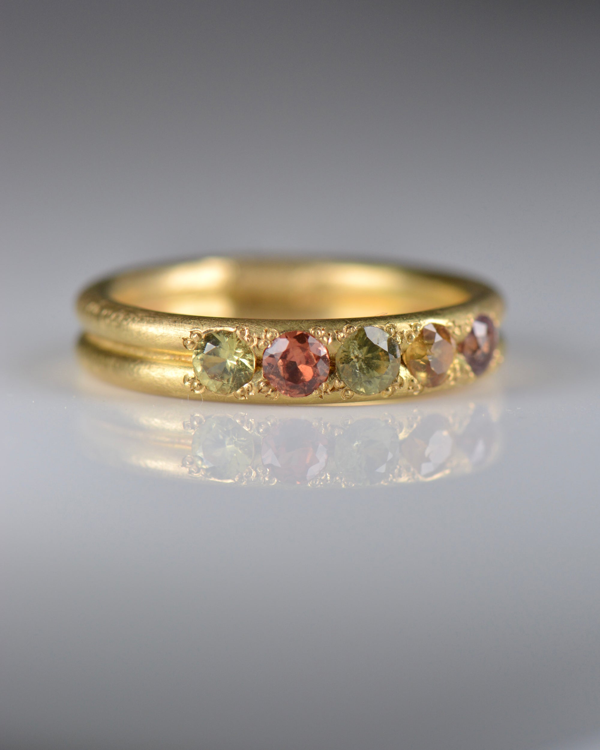 Handcrafted five stone sapphire ring band in 18k Fairmined gold, ethical jewellery and responsibly sourced materials.