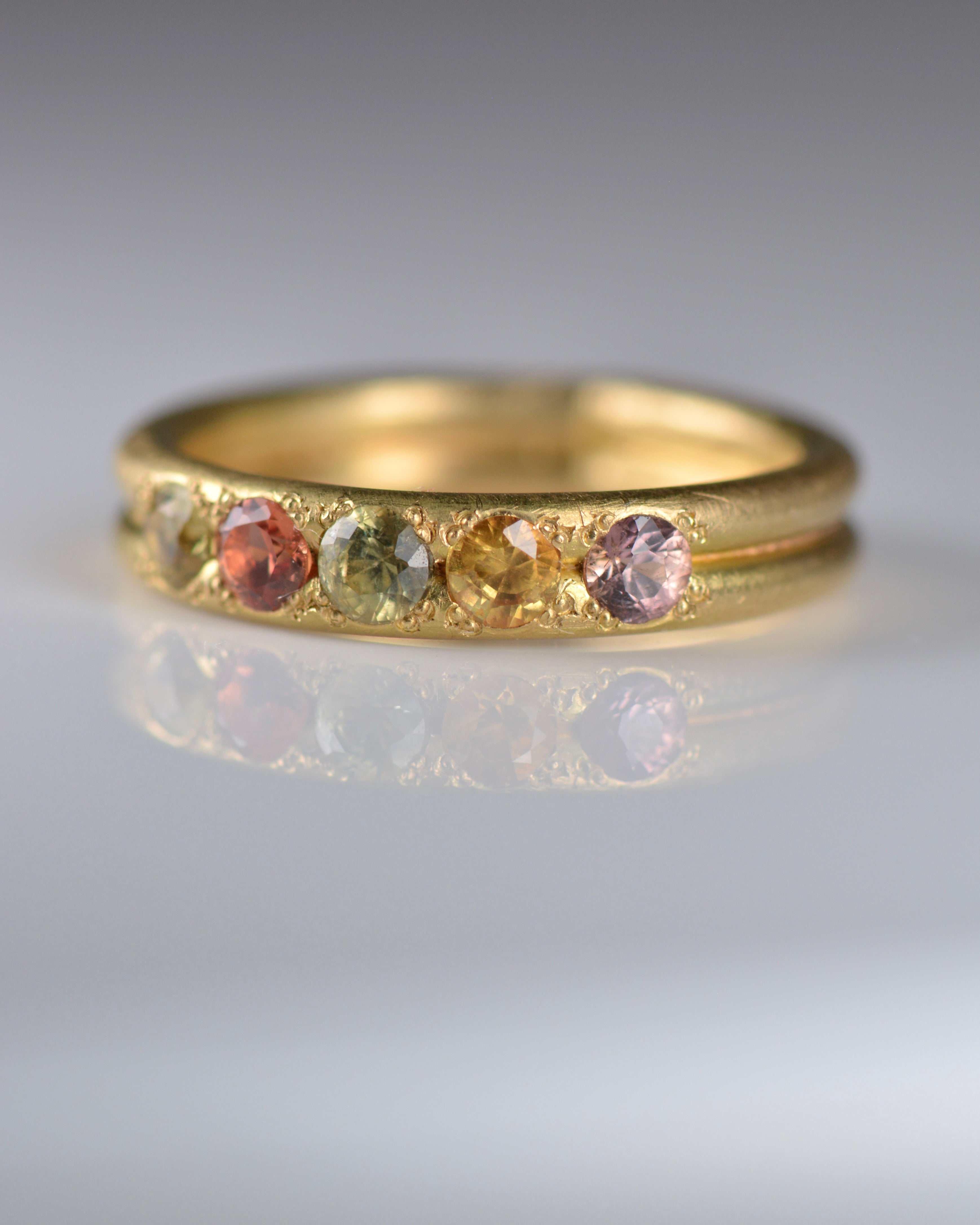 Handcrafted five stone sapphire ring band in 18k Fairmined gold, ethical jewellery and responsibly sourced materials.