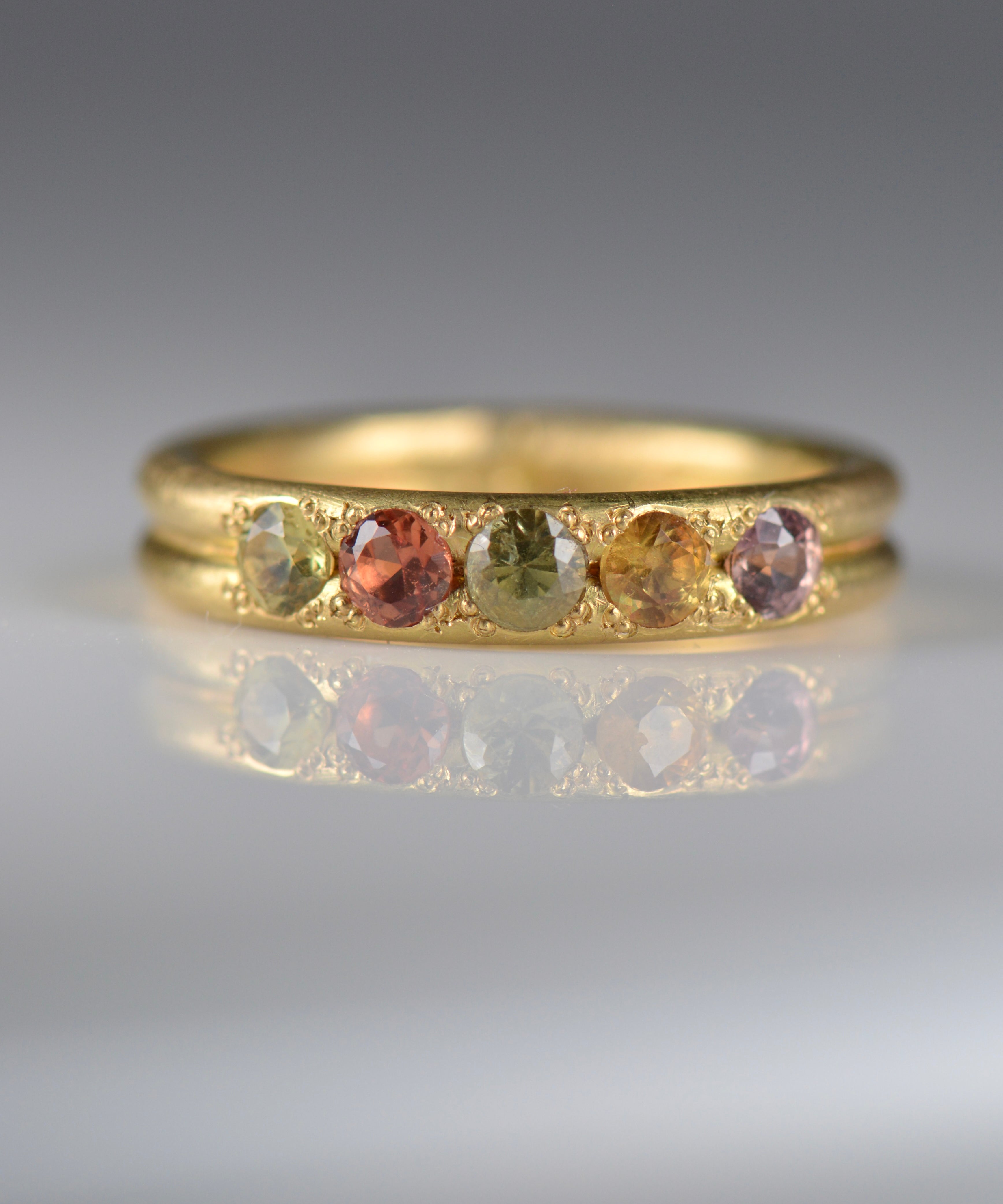 Handcrafted five stone sapphire ring band in 18k Fairmined gold, ethical jewellery and responsibly sourced materials.