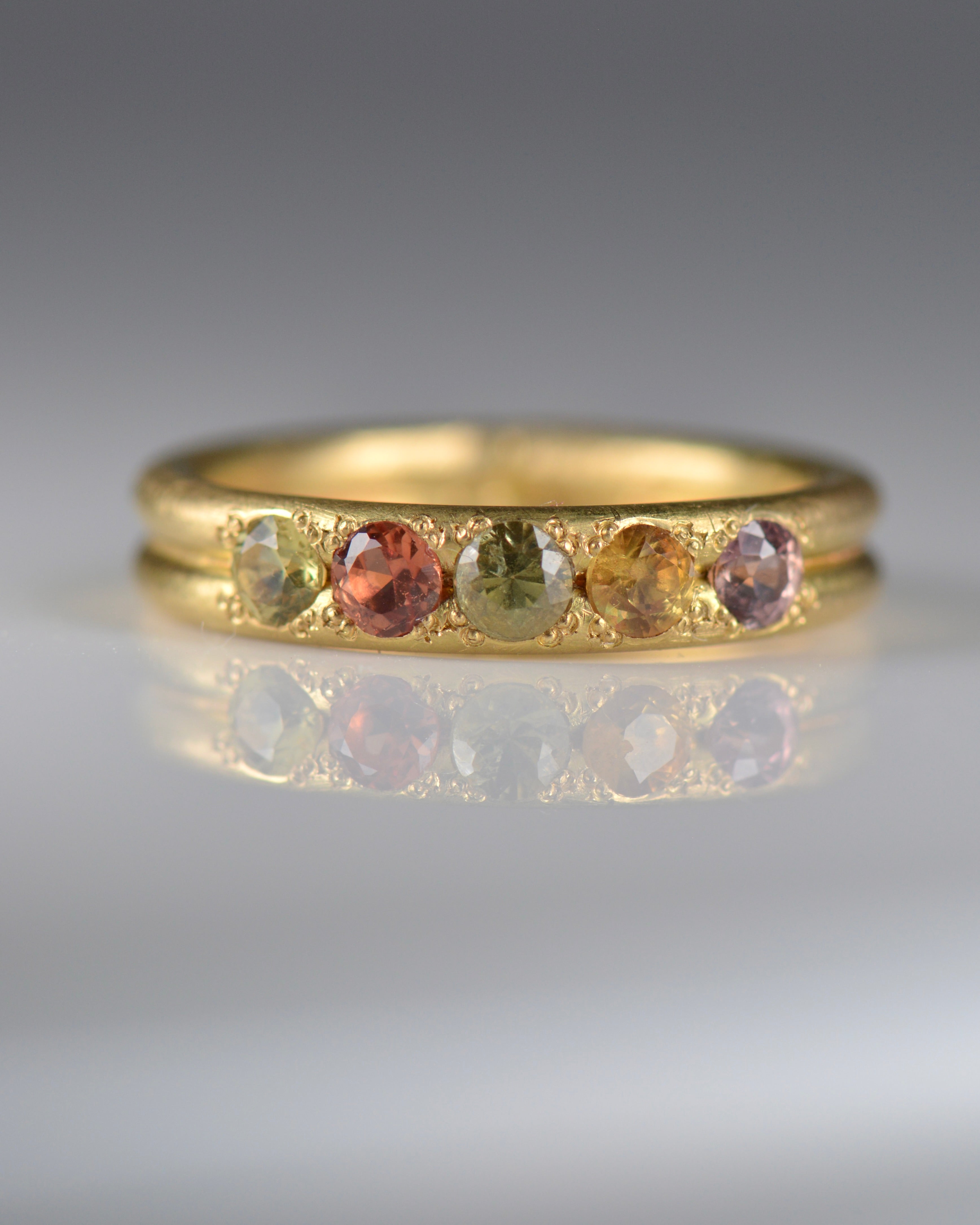 Handcrafted five stone sapphire ring band in 18k Fairmined gold, ethical jewellery and responsibly sourced materials.