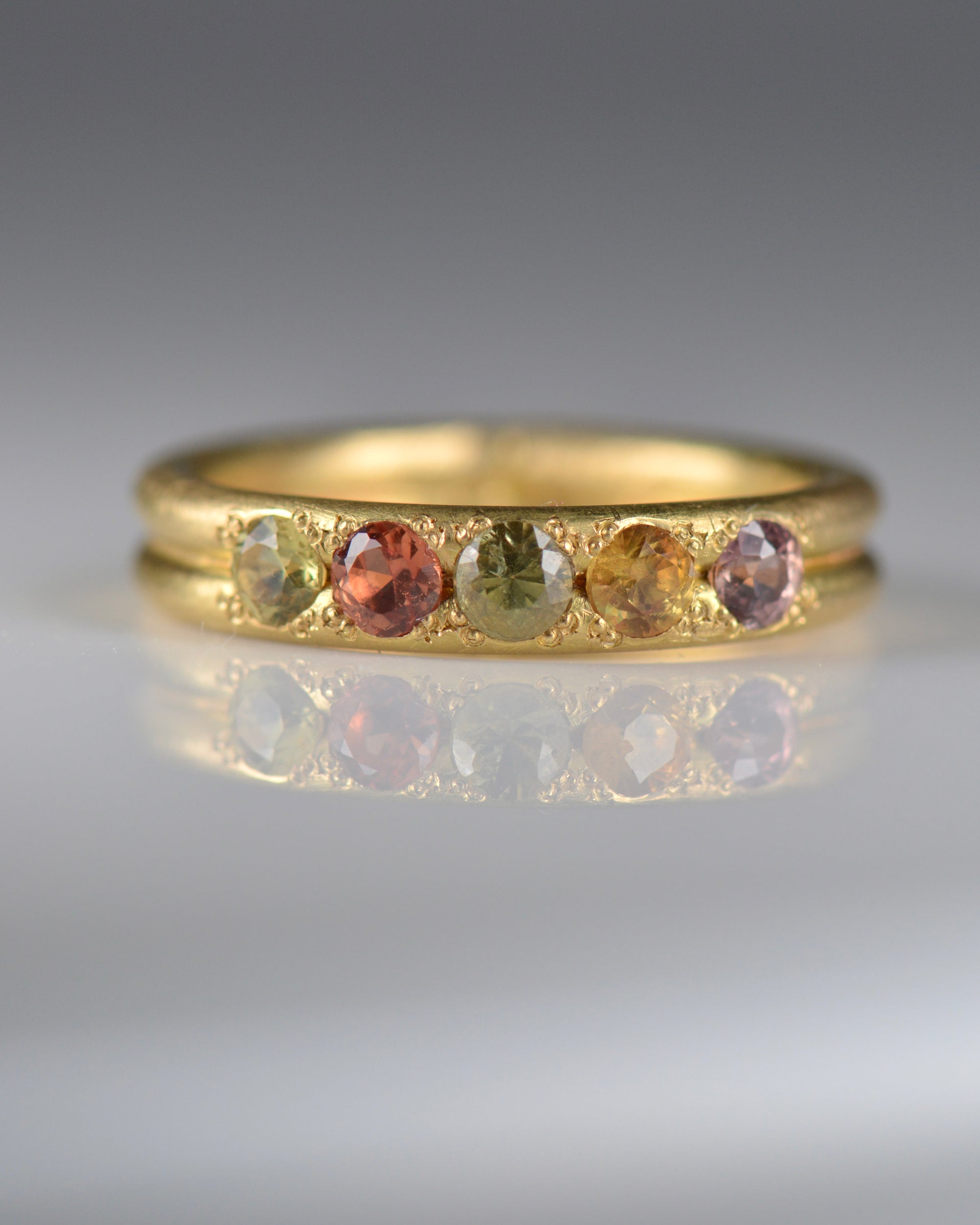 Handcrafted five stone sapphire ring band in 18k Fairmined gold, ethical jewellery and responsibly sourced materials.