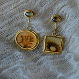 Dendritic agate and chrysoberyl mismatched earrings on gauze backdrop