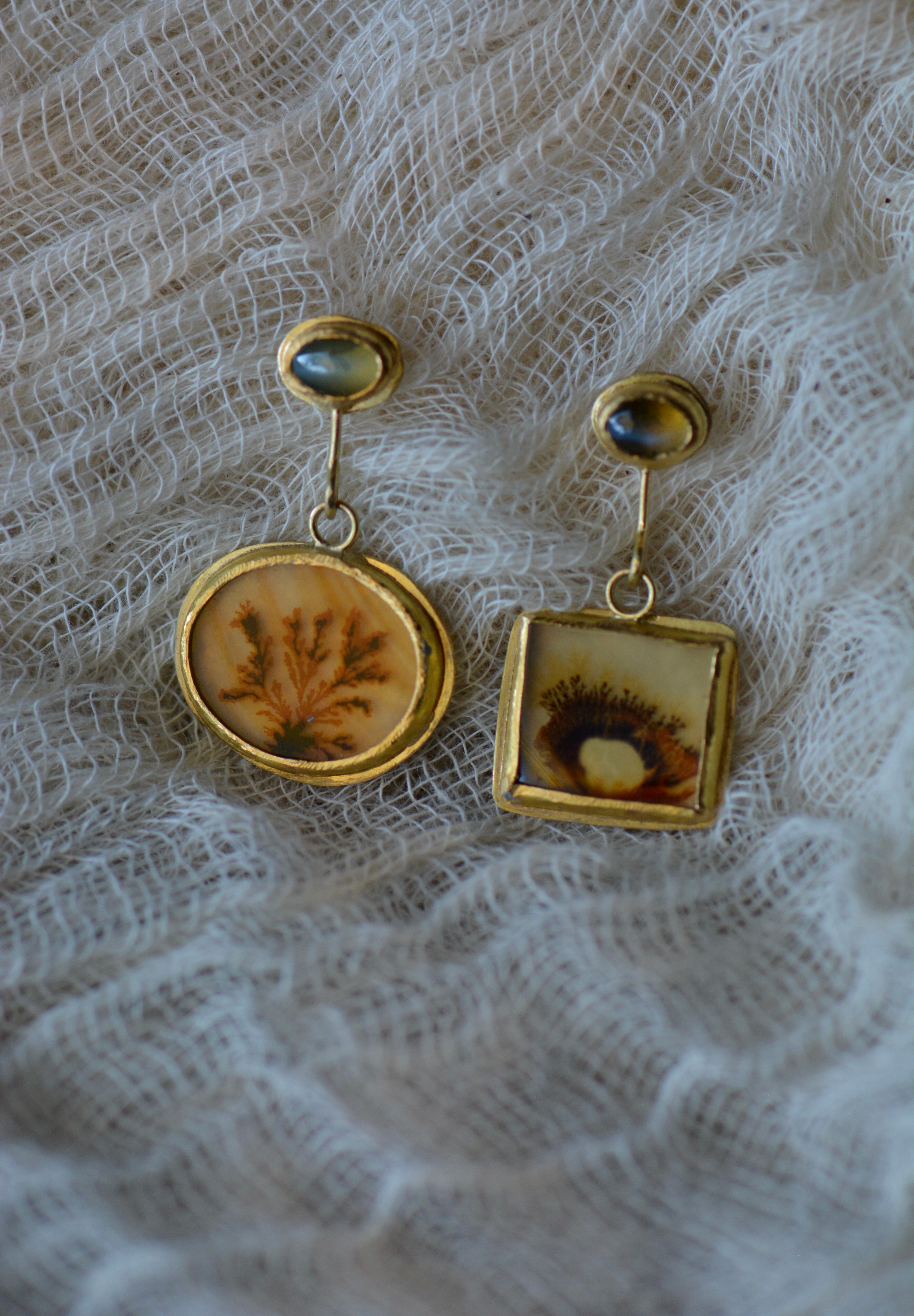 Dendritic agate and chrysoberyl mismatched earrings on gauze backdrop