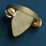 The reverse side of a cocktail ring is shown with solid gold backing and hand engraved hallmarks and signature.