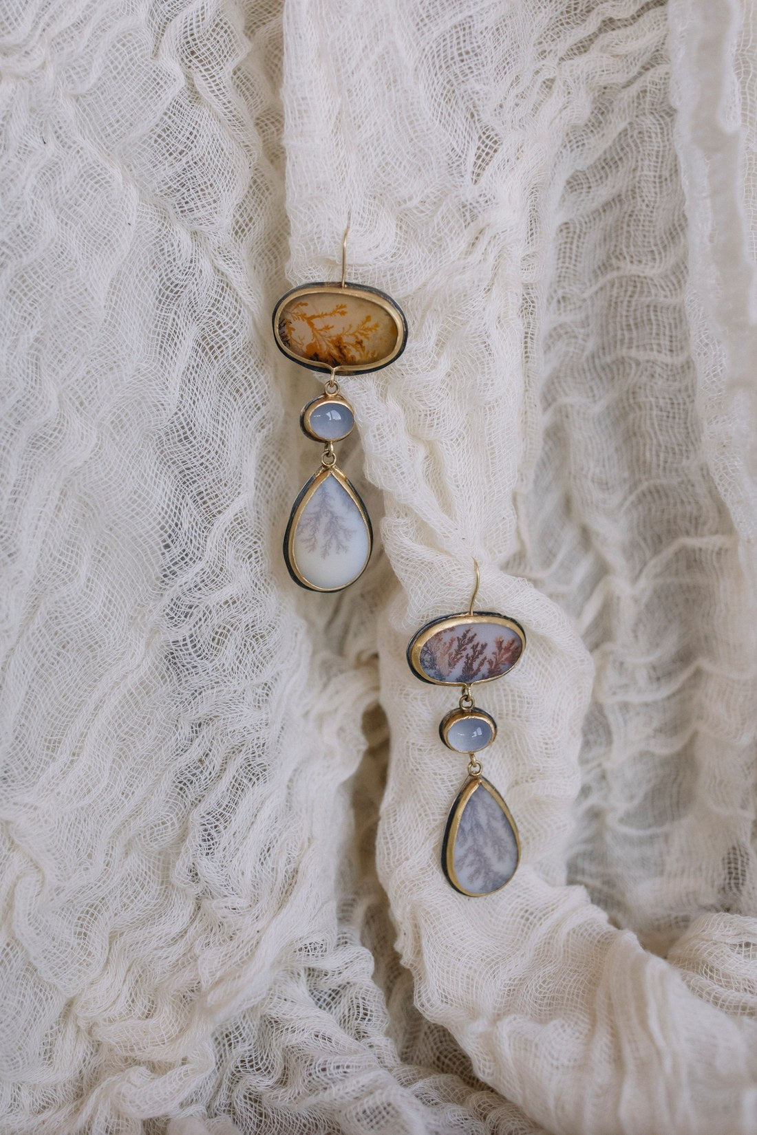 Dendritic agate drop earrings on ivory muslin