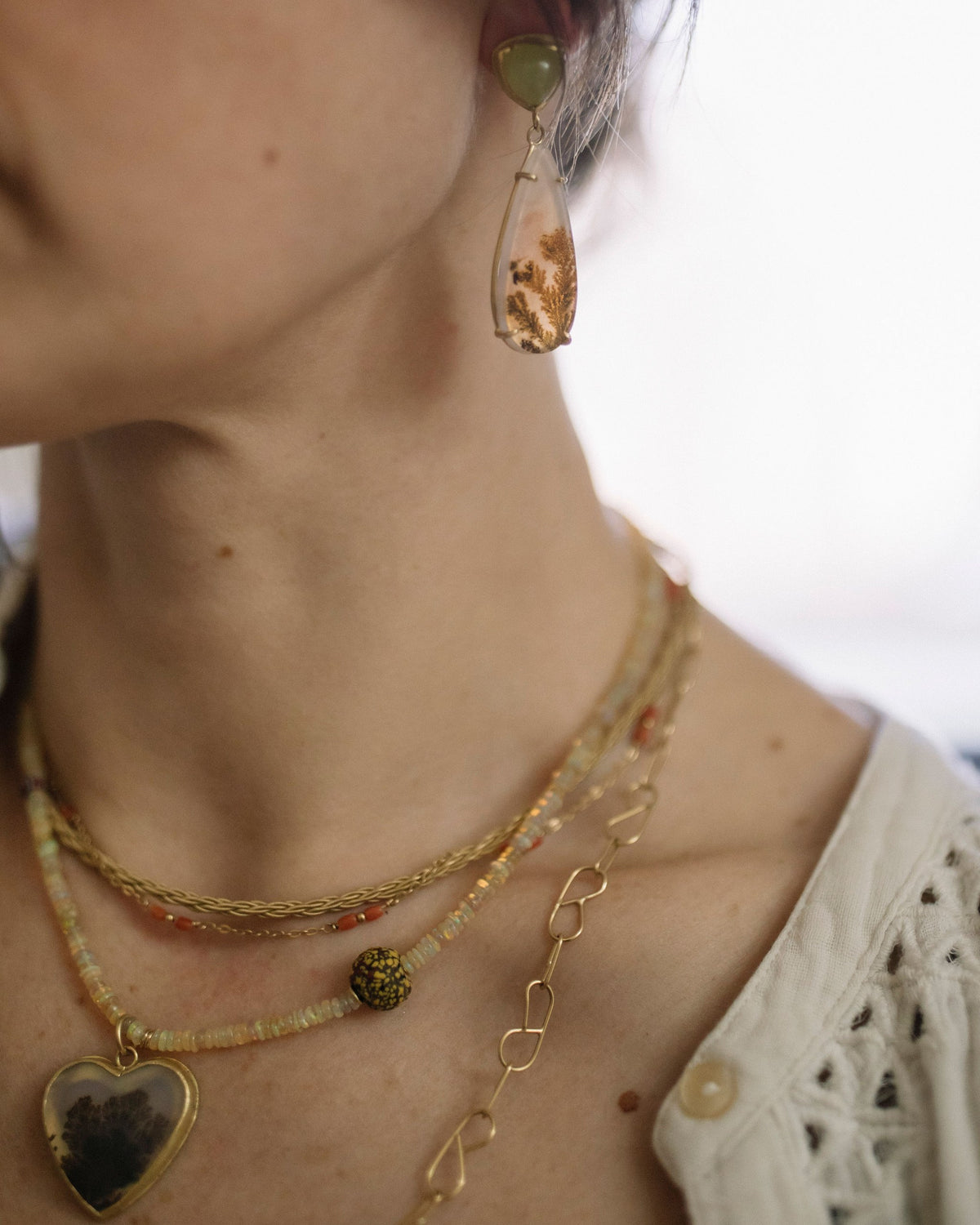 Lori wearing her layered gold necklaces and dendritic agate earring